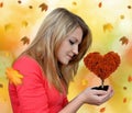 Girl holding in hand autumnal tree Royalty Free Stock Photo