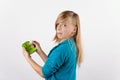 Girl holding a hearing aid and its box expressing negativity Royalty Free Stock Photo