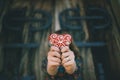 Girl holding a heart shaped decorated gingerbread,