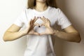 Girl holding heart shaped hands in front of her Royalty Free Stock Photo