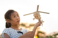 Girl holding helicopter wooden plane toy Royalty Free Stock Photo
