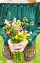 Girl holding in her hand a beautiful bouquet with multi-colored wild flowers. Amazing bunch of wilf flowers in the nature