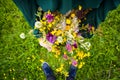 Girl holding in her hand a beautiful bouquet with multi-colored wild flowers. Amazing bunch of wilf flowers in the nature