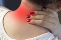 A girl is holding her neck, a painful neck, a pain, a red spot, a close-up scrag Royalty Free Stock Photo