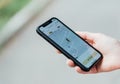 Girl holding iPhone showing Gett Taxi app on screen.