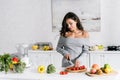 Girl holding knife near cherry tomatoes Royalty Free Stock Photo