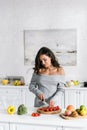 Girl holding knife near tasty cherry tomatoes Royalty Free Stock Photo