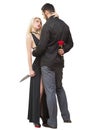 Girl holding knife traitor. man with rose in his