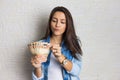 Girl holding a large amount of cash, a lot of money from Brazil. Business, income, loan, pay, buy, wealth