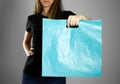 Girl holding a light blue plastic bag. Close up. Isolated background Royalty Free Stock Photo