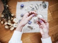 A girl is holding a little glass jar on her altar in lavender tones