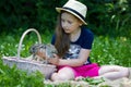 Girl is holding a little rabbit