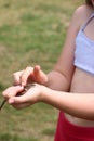 The girl is holding a lizard in her hands. Close-up. Royalty Free Stock Photo