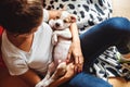 Girl holding and looking at the sleepy puppy