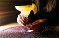 Girl holding margarita cocktail on the table in the restaurant. Alcoholic drinks. Beautiful hands