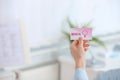 Girl holding medical business card indoors. Women`s health service Royalty Free Stock Photo