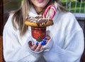 girl holding a milkshake with donuts and other sweets in a jar. Royalty Free Stock Photo