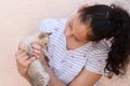 Happy child holds a cat in her arms. Girl caught a little kitty. Royalty Free Stock Photo