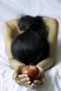 Girl holding one red apple in her hands Royalty Free Stock Photo