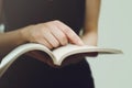 Girl holding an open book in her hands, close-up Royalty Free Stock Photo