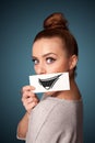 girl holding paper with funny smiley drawing on gradient background Royalty Free Stock Photo