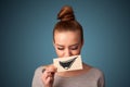 Girl holding paper with funny smiley drawing on gradient background Royalty Free Stock Photo