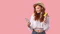 Girl Holding Phone And Credit Card Standing On Pink Background Royalty Free Stock Photo