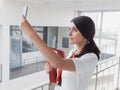 The girl is holding the phone in her hands. Beautiful Smiling Businesswoman is calling by phone. Portrait of Business Woman With a Royalty Free Stock Photo