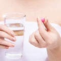 Girl holding a pill. Vitamins concept. Beautiful portrait Royalty Free Stock Photo