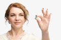 Girl holding a pill. Vitamins concept. Beautiful portrait on white background Royalty Free Stock Photo