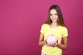 girl holding pink piggybank Royalty Free Stock Photo