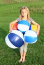 Girl holding planty of inflating balls Royalty Free Stock Photo