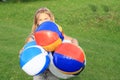 Girl holding planty of inflating balls Royalty Free Stock Photo