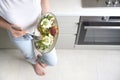 Girl holding a plate with toast made with microgreens, poached eggs, avocado, asparagus and cheese Royalty Free Stock Photo