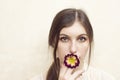 A girl holding primerose flower pretending smoking