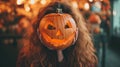 Girl holding a pumpkin for Halloween in front of her head Royalty Free Stock Photo