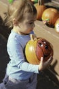 Girl Holding a Pumpkin