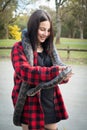 Girl holding python snake