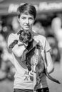 A girl holding a rescue dog in the park at a dog show