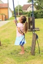 Girl holding rope of a broken swing
