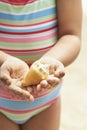 Girl Holding Seashell On Beach Royalty Free Stock Photo