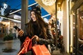 Girl holding shopping bags and looking at her phone Royalty Free Stock Photo