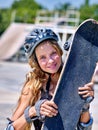 Girl holding a skateboard in hands. Royalty Free Stock Photo