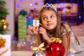 Girl holding a small pretty gift in her hands