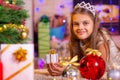 Girl holding a small pretty gift in her hands, and looks into the frame