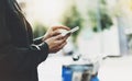 Girl holding smart phone on background sun atmospheric city and bike, hipster using in female hands and texting mobile, street Royalty Free Stock Photo