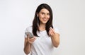 Girl Holding Smartphone Offering Earbud Listening To Music, White Background