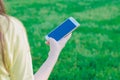 Girl holding a smartphone outdoors. White phone mockup