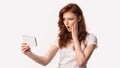 Girl Holding Smartphone Reading Shocking News Online, White Background