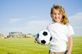 Girl holding soccer ball smiling Royalty Free Stock Photo